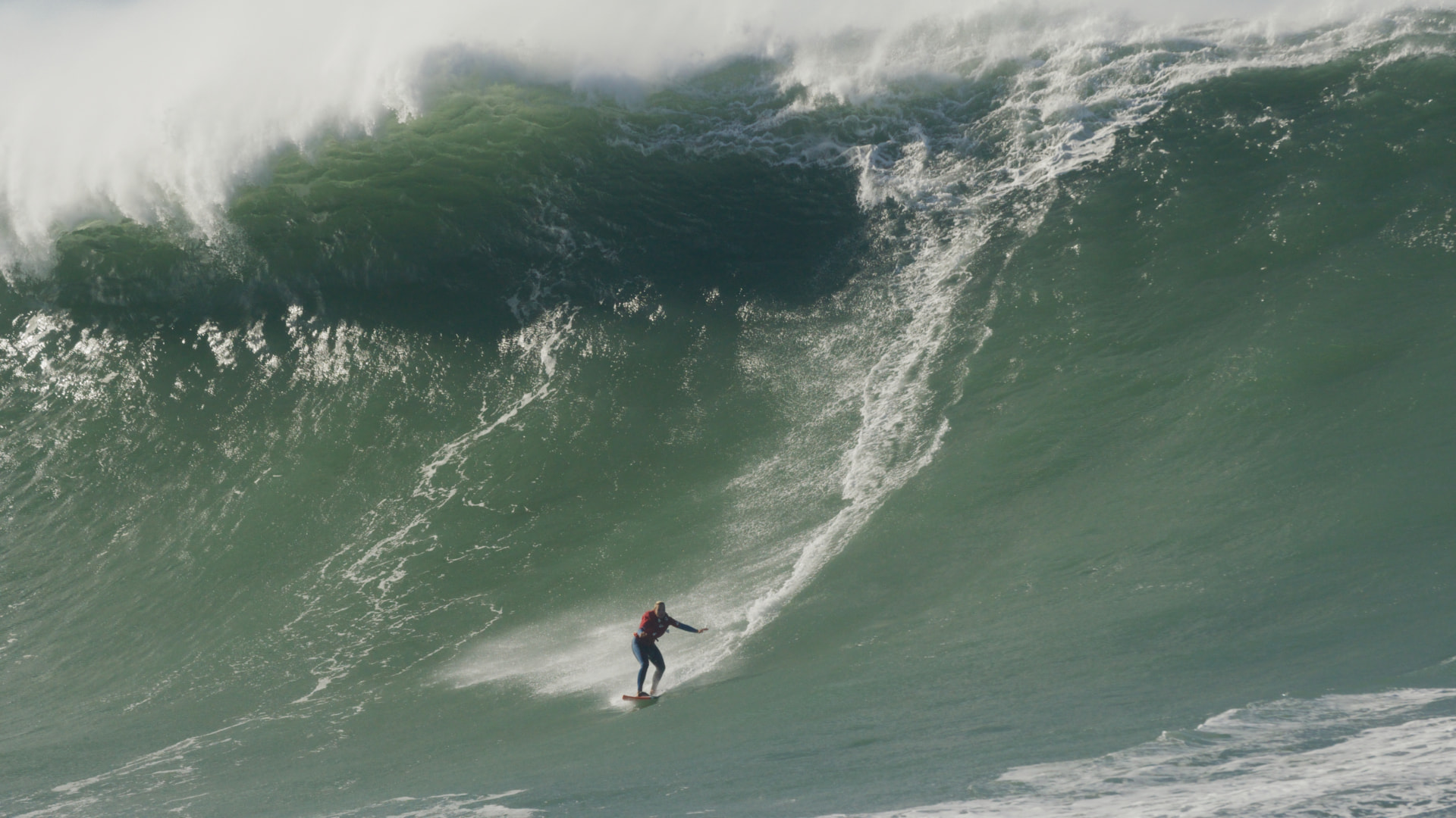 Katrīna Krūze riding a big wave at Nazaré, Portugal
